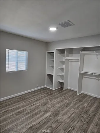 a view of a room with wooden floor and closet