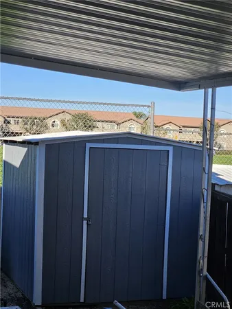 a view of a closet area with wooden floor
