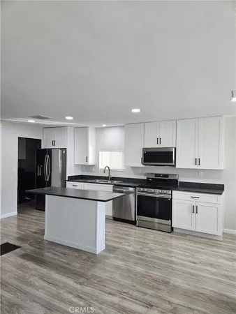 a kitchen with stainless steel appliances granite countertop a stove and a sink