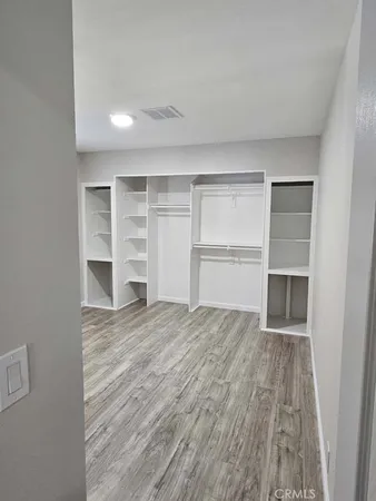 a view of an empty room with a closet and a window