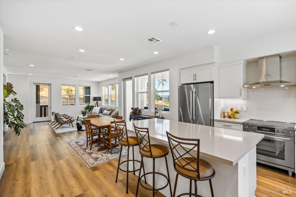 649 Semillon Lane Santa Rosa, CA 95403 - Photo 14 of 38 Spacious kitchen featuring quartz countertops, shaker-style cabinetry, and stainless steel appliances.