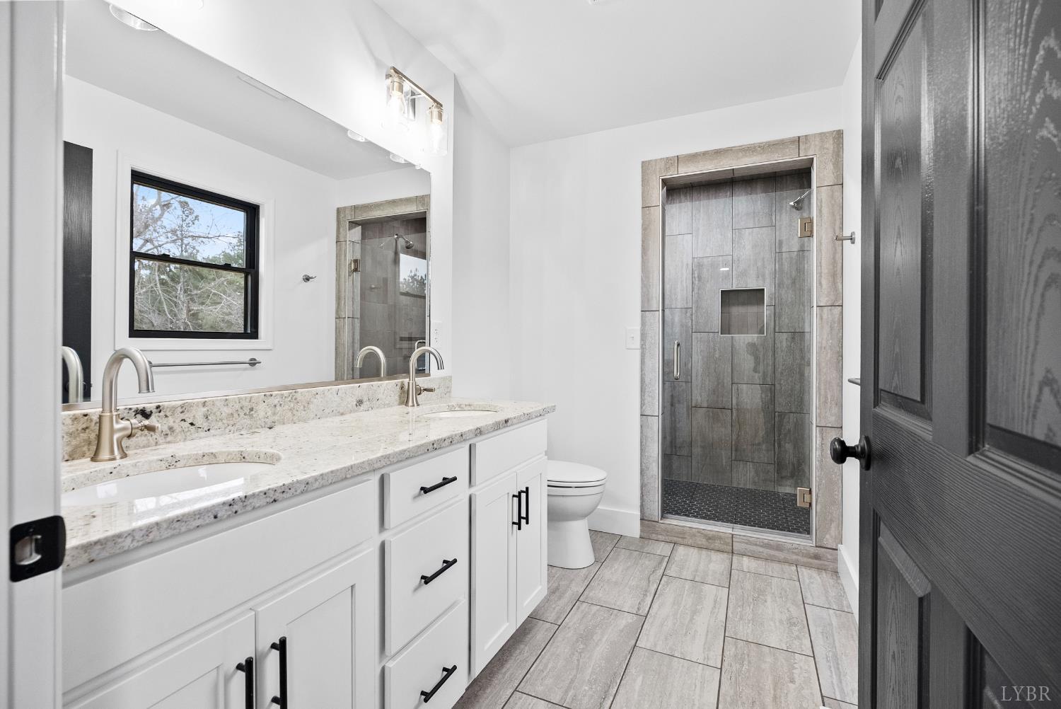 112 Savage Drive Rustburg, VA 24588 - Photo 22 of 51 a bathroom with a granite countertop sink a mirror and a shower