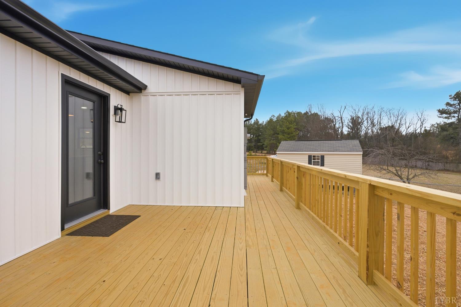 112 Savage Drive Rustburg, VA 24588 - Photo 35 of 51 a view of a balcony with wooden floor and lake view