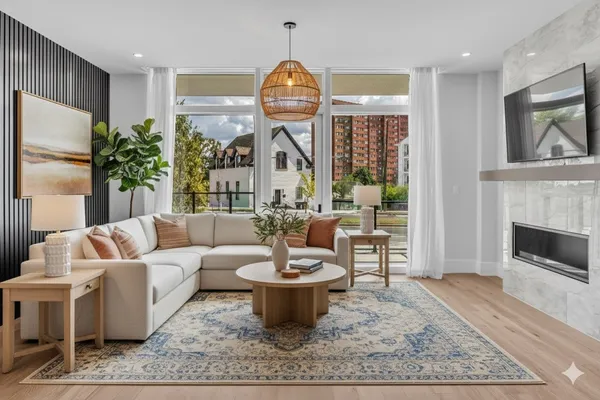 a living room with furniture a window and a fireplace