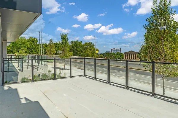 a living room with furniture and a floor to ceiling window