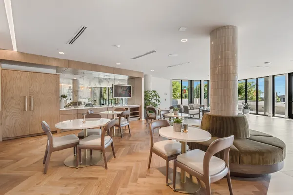a dining room with furniture and wooden floor
