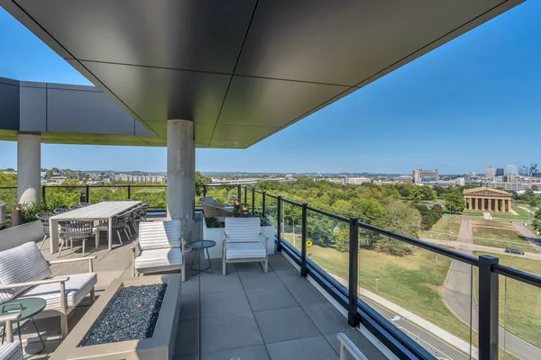 a view of a patio with chairs and a table