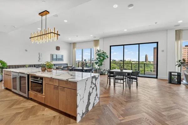 a view of balcony with two chairs and a potted plant