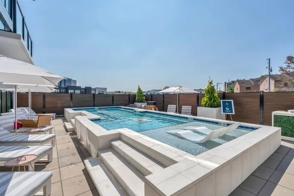 a living room with furniture a rug and gym equipment