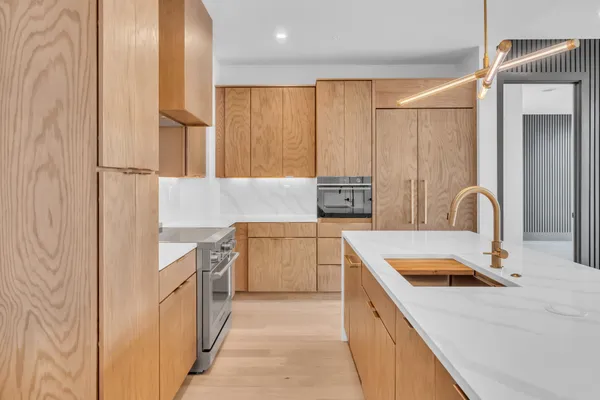 a kitchen with a sink stove and refrigerator