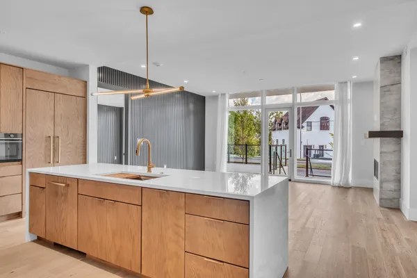 a view of an empty room with a fireplace and a window