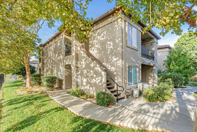 a view of a brick house with a yard
