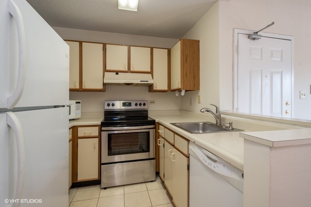 1905 North Hicks Road, Unit 205 Palatine, IL 60074 - Photo 5 of 10 a kitchen with stainless steel appliances granite countertop a sink stove and refrigerator