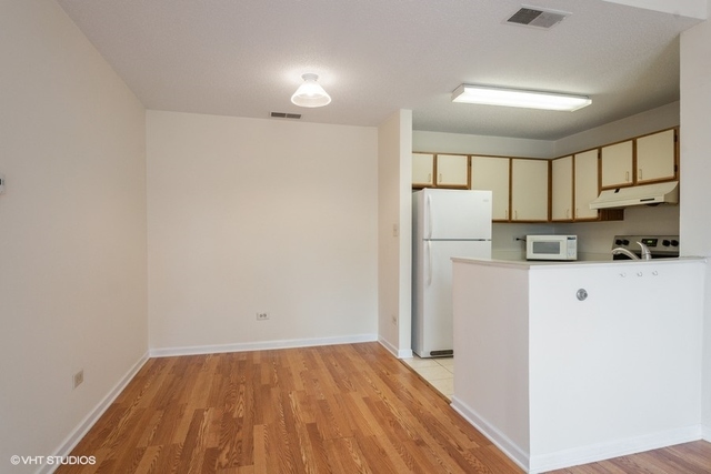 1905 North Hicks Road, Unit 205 Palatine, IL 60074 - Photo 6 of 10 a view of a kitchen with wooden floor and electronic appliances