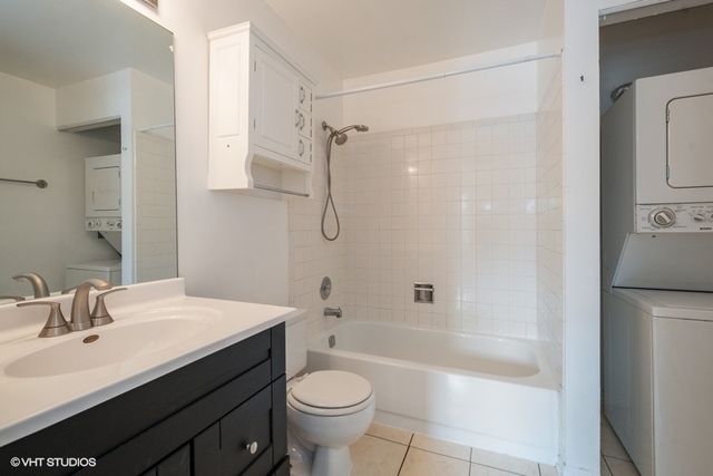 1905 North Hicks Road, Unit 205 Palatine, IL 60074 - Photo 8 of 10 a bathroom with a sink a toilet and shower