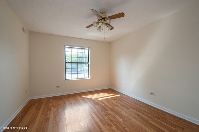 1905 North Hicks Road, Unit 205 Palatine, IL 60074 - Photo 9 of 10 wooden floor in an empty room with a window