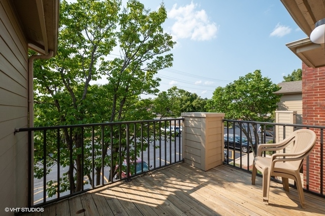 1905 North Hicks Road, Unit 205 Palatine, IL 60074 - Photo 10 of 10 a view of balcony with wooden floor and outdoor seating