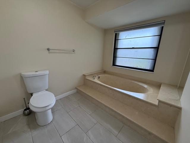 6533 Sweet Maple Lane Boca Raton, FL 33433 - Photo 14 of 20 a bathroom with a toilet and a bathtub