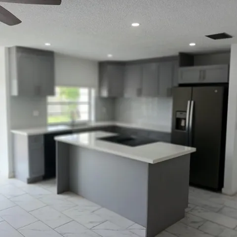 a view of an empty room with a floor to ceiling window and an outdoor view