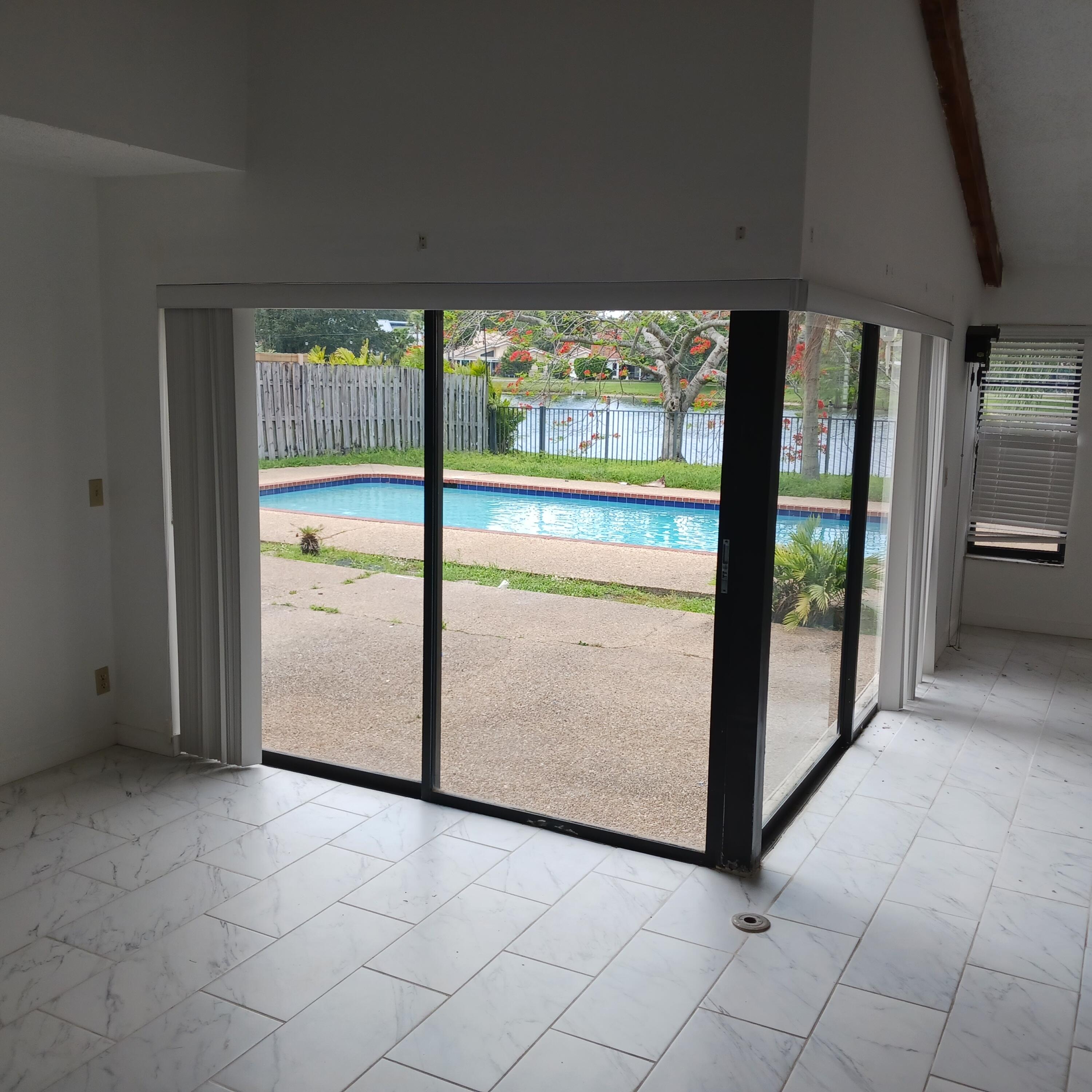 6533 Sweet Maple Lane Boca Raton, FL 33433 - Photo 5 of 20 a view of an empty room with a floor to ceiling window and an outdoor view