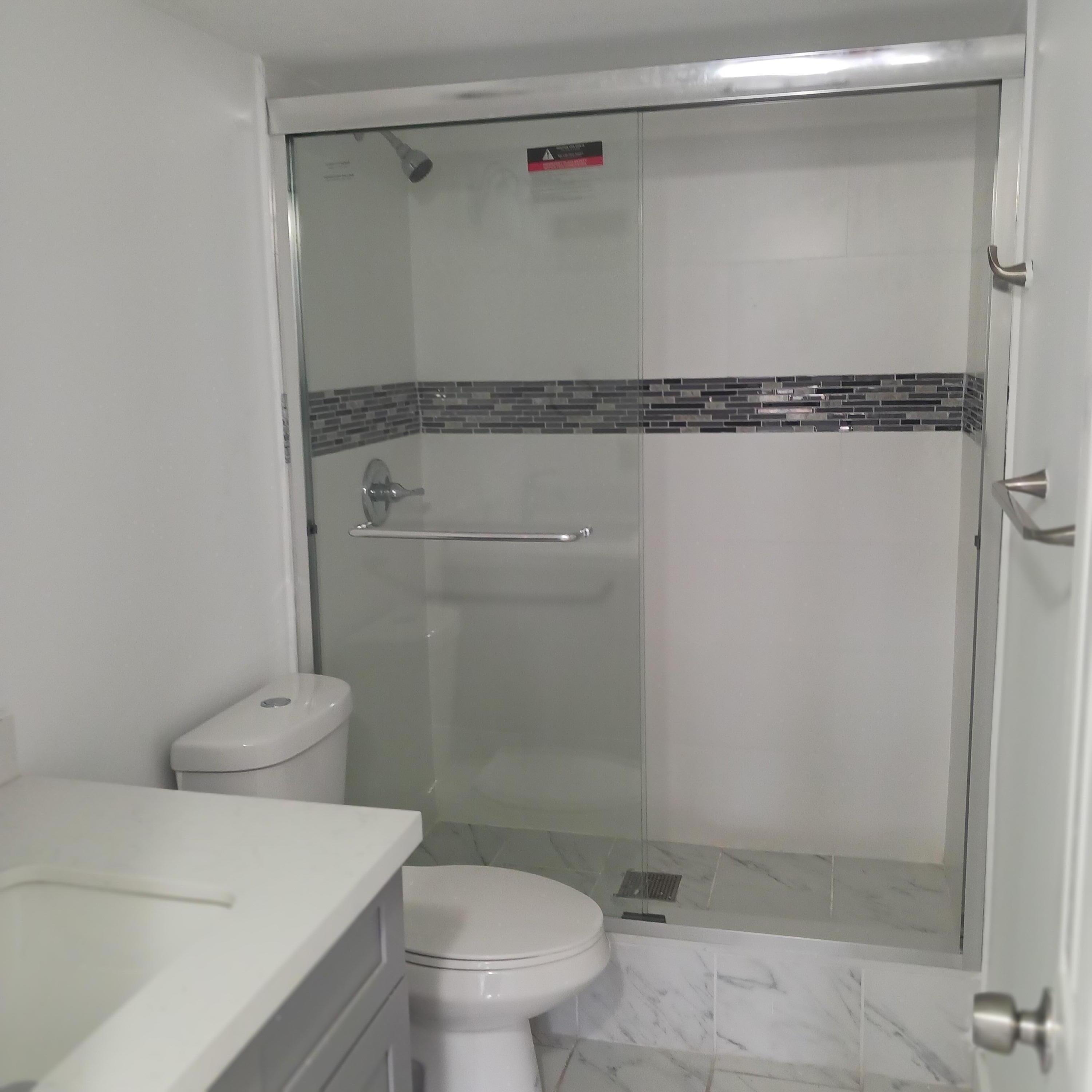 6533 Sweet Maple Lane Boca Raton, FL 33433 - Photo 6 of 20 a bathroom with a granite countertop toilet and a shower