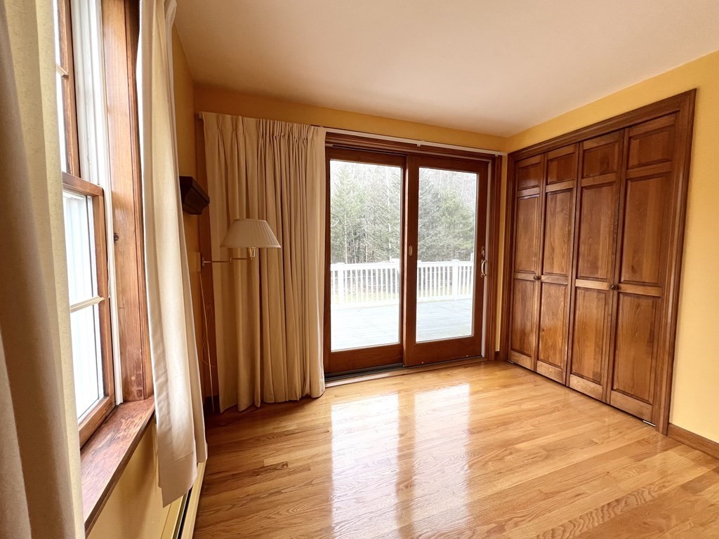 68 Deer Run Circle Barre, MA 01005 - Photo 12 of 26 a view of an empty room with wooden floor and a window
