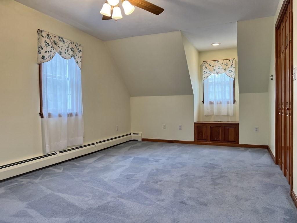 68 Deer Run Circle Barre, MA 01005 - Photo 17 of 26 an empty room with chandelier fan and windows
