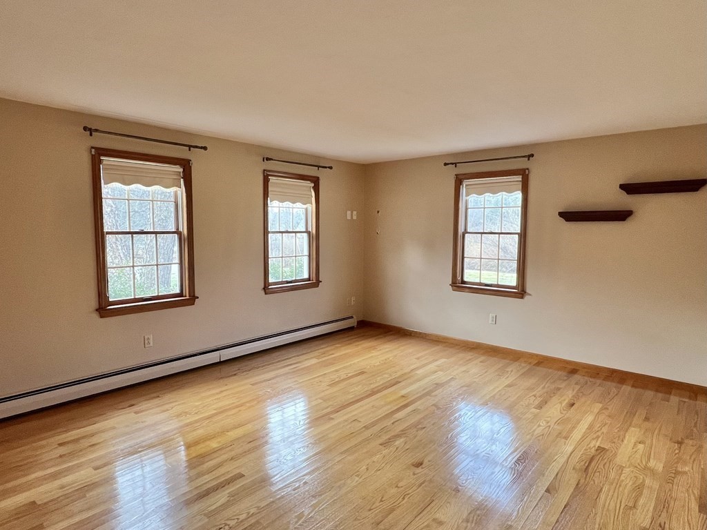 68 Deer Run Circle Barre, MA 01005 - Photo 7 of 26 a view of an empty room with wooden floor and a window