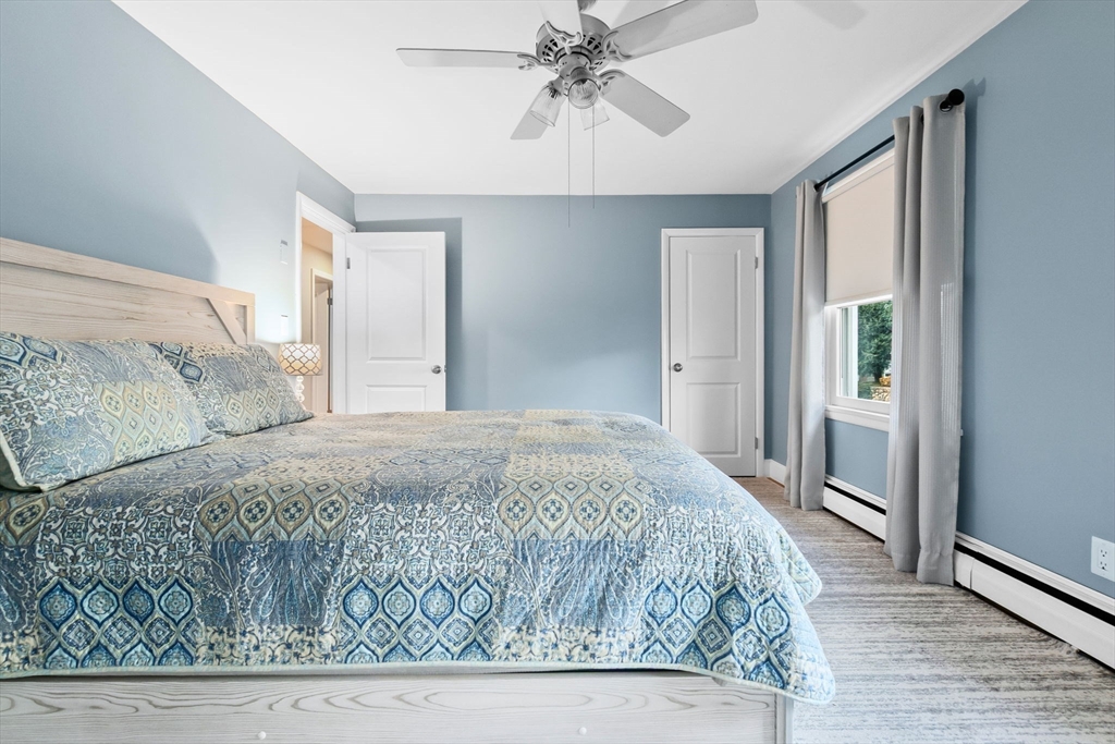 11 Wilson Avenue Wakefield, MA 01880 - Photo 17 of 42 a bedroom with a bed and a chandelier