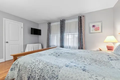 a bedroom with a bed and a flat screen tv