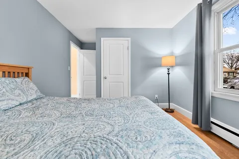 a bedroom with a bed and a lamp