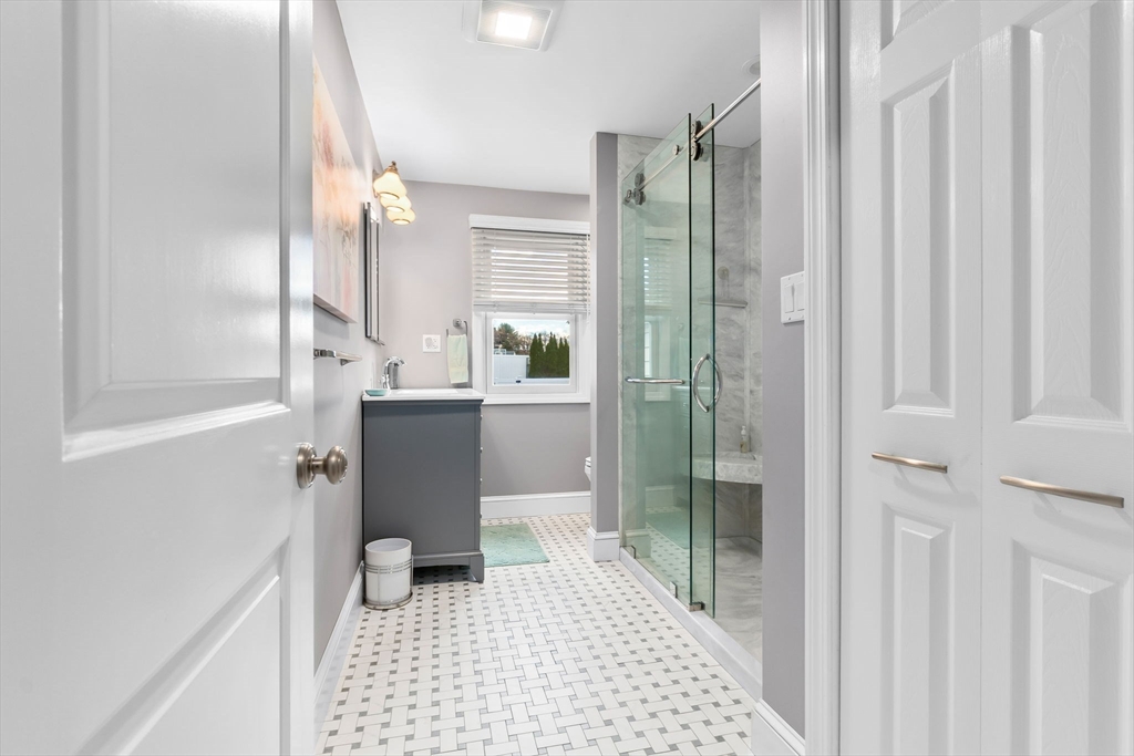 11 Wilson Avenue Wakefield, MA 01880 - Photo 21 of 42 a bathroom with a sink a toilet a window and vanity