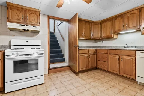 a kitchen with white cabinets and white appliances