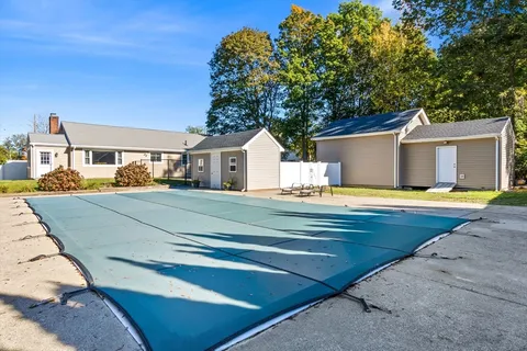 a view of house with swimming pool outdoor seating