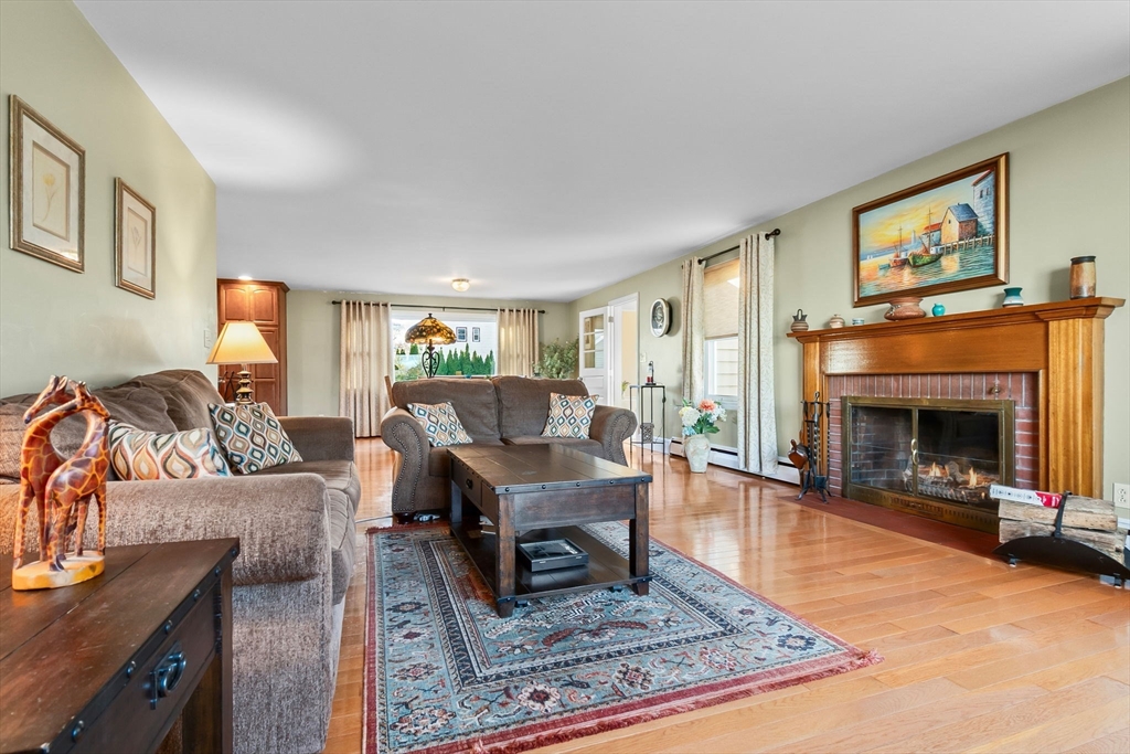 11 Wilson Avenue Wakefield, MA 01880 - Photo 5 of 42 a living room with furniture a fireplace and a flat screen tv