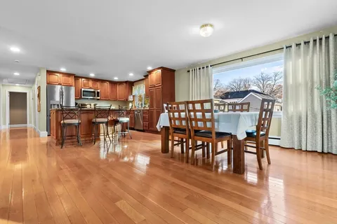 a view of a dining room with furniture window and wooden floor