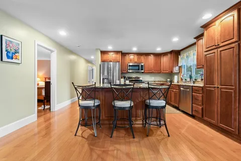 a kitchen with a table chairs refrigerator and cabinets