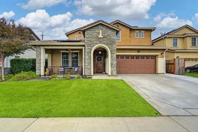 a front view of a house with a yard