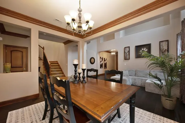 a view of a dining room with furniture and a chandelier
