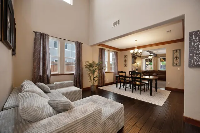 a living room with furniture wooden floor and a flat screen tv