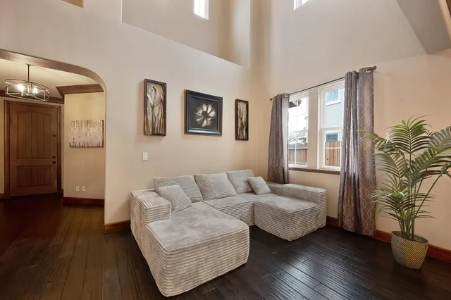 a living room with furniture and wooden floor