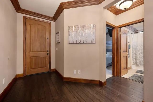 an empty room with wooden floor and a large window
