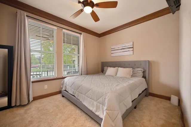 a bedroom with a bed and a large window