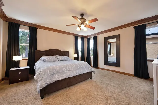 a spacious bedroom with a bed and a large window