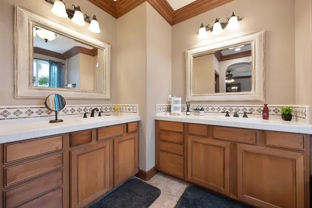 a bathroom with a sink vanity and mirror
