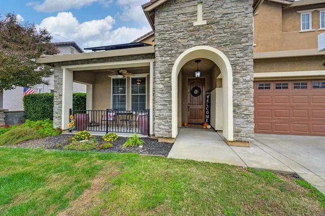 a view of a house with garden and porch