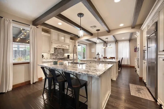 a large kitchen with a table and chairs