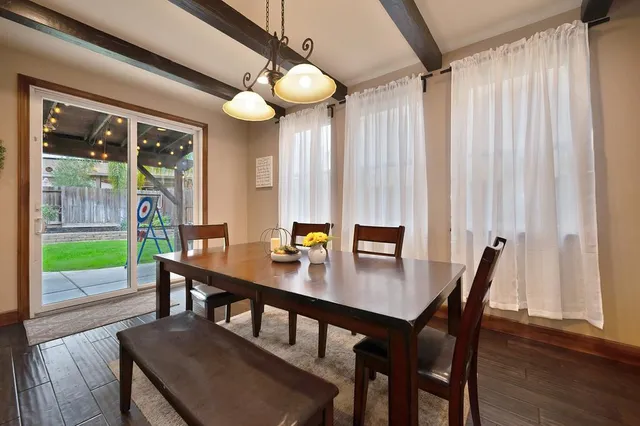 a view of a dining room with furniture window and wooden floor