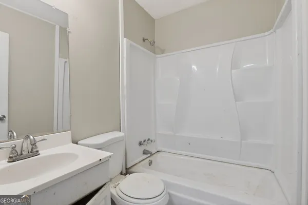 a bathroom with a toilet a sink and a bathtub