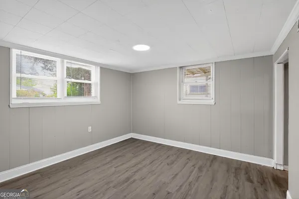 a view of a room with wooden floor and windows